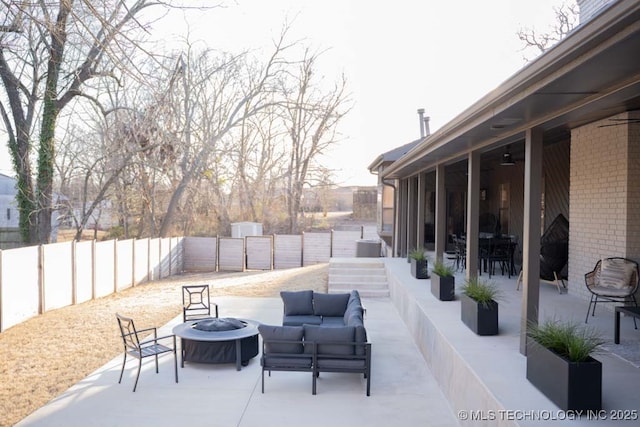 view of patio / terrace featuring an outdoor fire pit and a fenced backyard