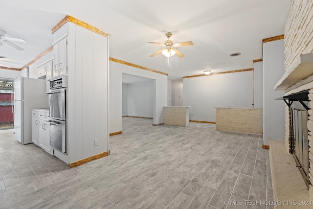 unfurnished living room featuring ceiling fan