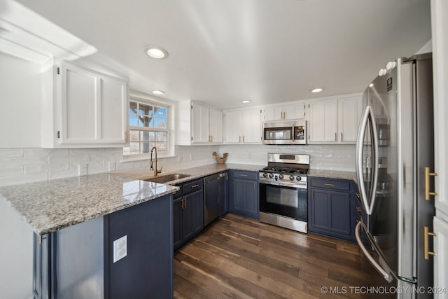 kitchen featuring light stone countertops, sink, white cabinetry, and stainless steel appliances