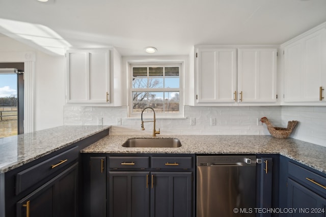 kitchen featuring dishwasher, light stone countertops, white cabinetry, and sink