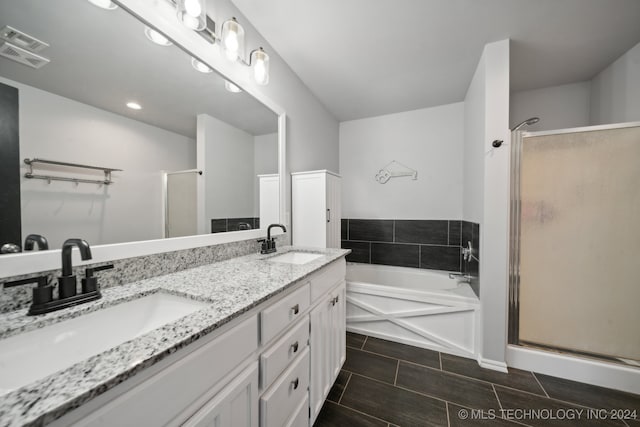 bathroom with vanity and independent shower and bath