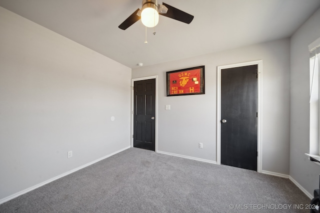 unfurnished bedroom with ceiling fan and carpet floors