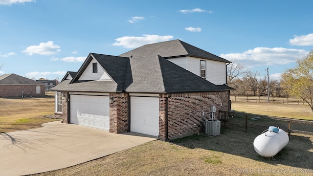 view of property exterior featuring a garage, central air condition unit, and a yard