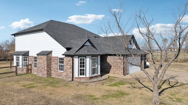 view of side of property featuring a yard and a garage