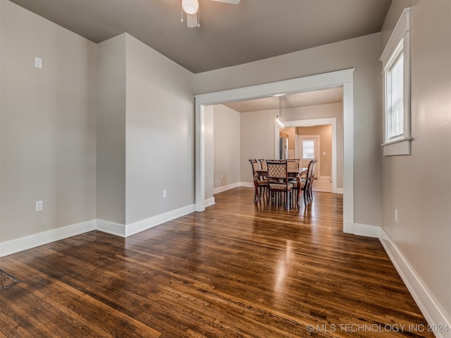 dining room with ceiling fan and dark wood-type flooring