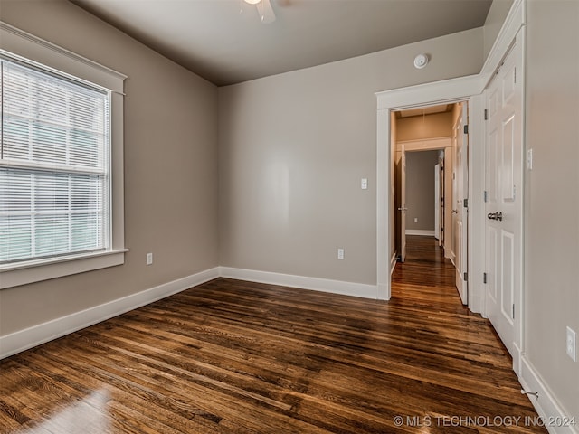 empty room featuring dark hardwood / wood-style flooring and ceiling fan