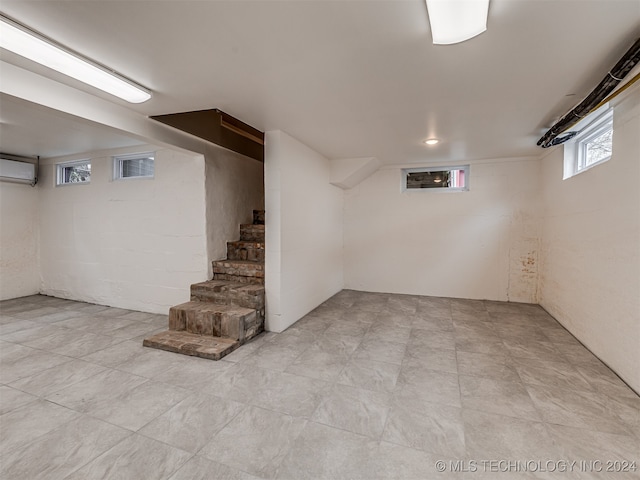 basement with a wall mounted air conditioner