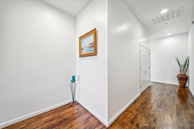 corridor with dark hardwood / wood-style flooring