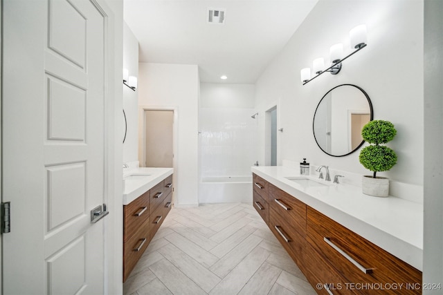 bathroom featuring vanity and  shower combination