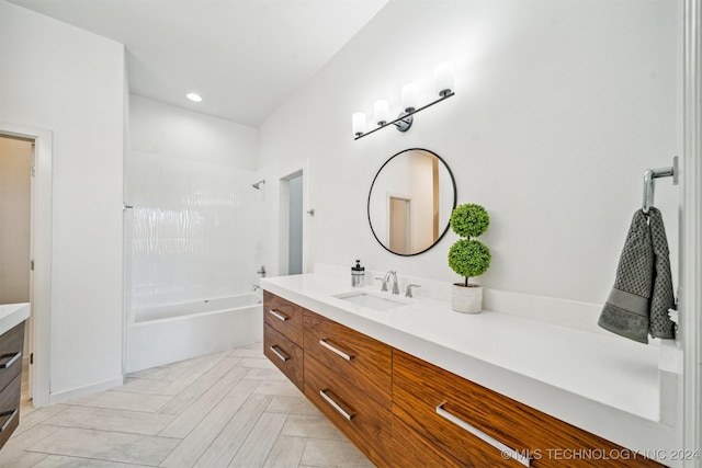 bathroom with shower / bathing tub combination and vanity