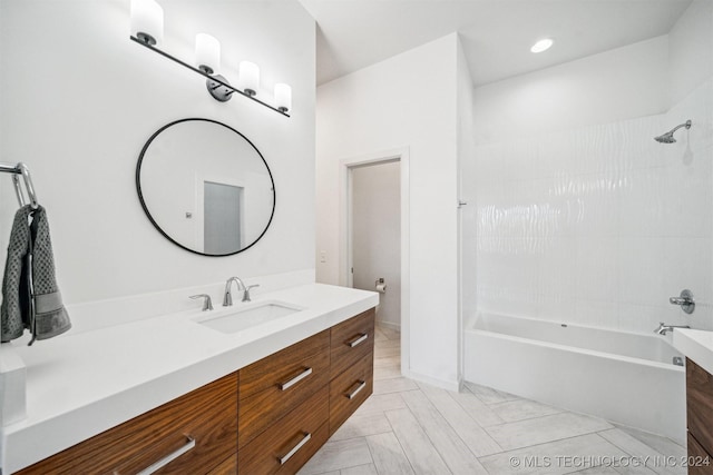 bathroom featuring vanity and tiled shower / bath combo