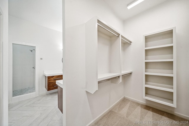 spacious closet with light parquet floors