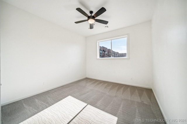 carpeted empty room with ceiling fan