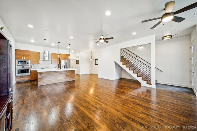 living room featuring ceiling fan and dark wood-type flooring