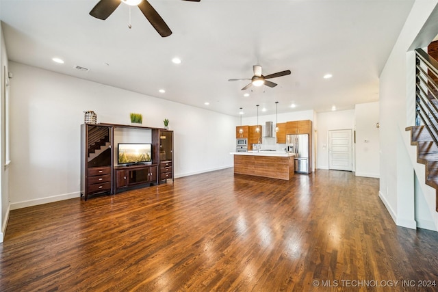 living room featuring ceiling fan and dark hardwood / wood-style floors