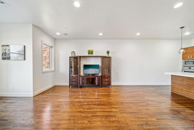 unfurnished living room with dark hardwood / wood-style flooring