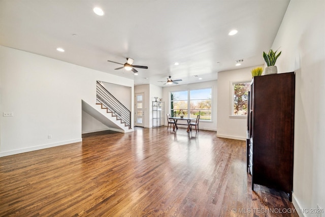 living room with hardwood / wood-style flooring and ceiling fan