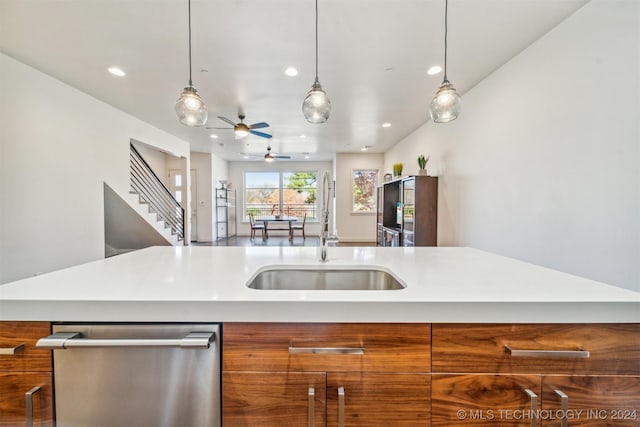 kitchen featuring pendant lighting, ceiling fan, sink, and stainless steel dishwasher