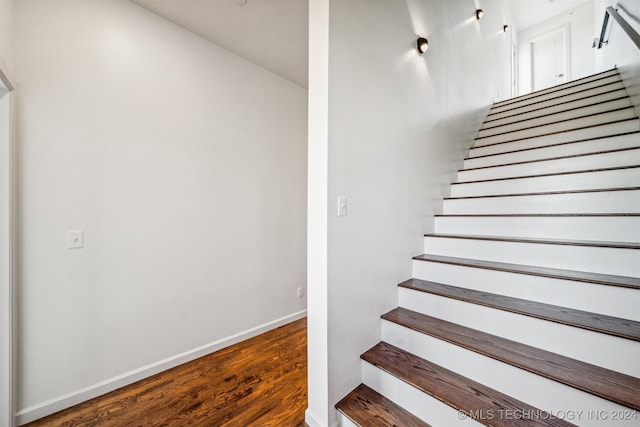 stairway with hardwood / wood-style flooring