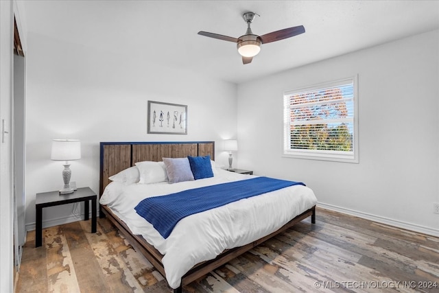 bedroom featuring wood-type flooring and ceiling fan