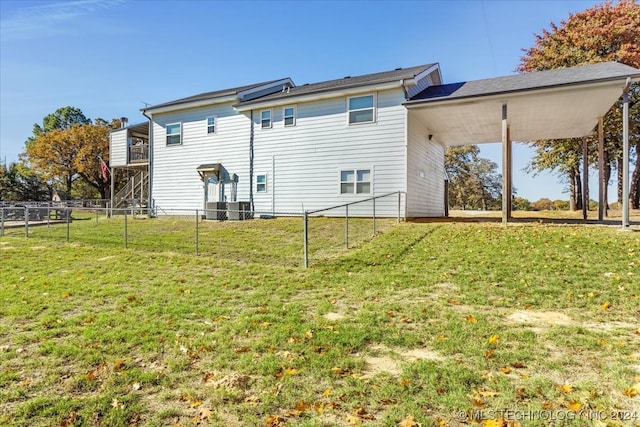 rear view of house featuring a yard