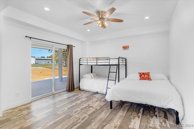 bedroom featuring ceiling fan, access to exterior, and wood-type flooring