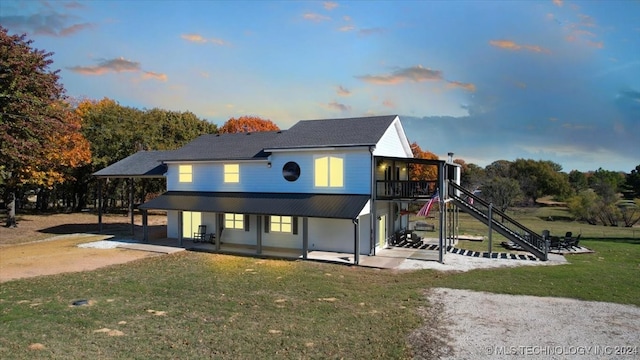 view of front of property featuring a lawn and a patio