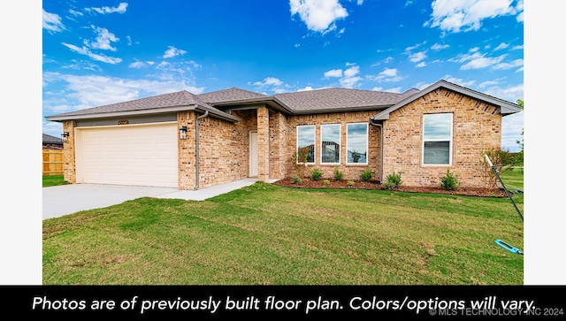 view of front of house featuring a front lawn and a garage