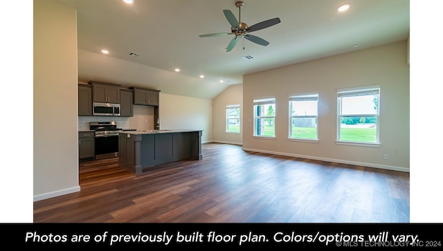 kitchen featuring ceiling fan, stainless steel appliances, dark hardwood / wood-style floors, vaulted ceiling, and a kitchen island