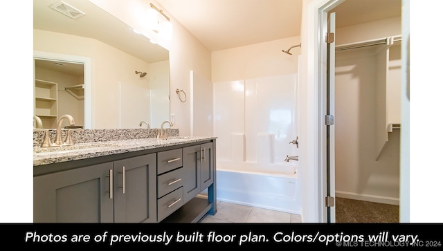 bathroom with shower / bathing tub combination, vanity, and tile patterned floors