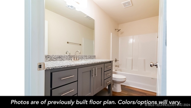 full bathroom with shower / bath combination, vanity, wood-type flooring, and toilet