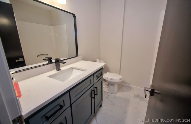 bathroom featuring vanity, toilet, and walk in shower