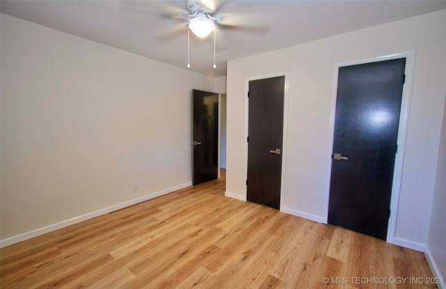 unfurnished bedroom featuring ceiling fan and light hardwood / wood-style floors