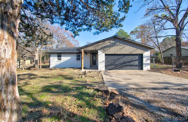 single story home with a garage and a front lawn