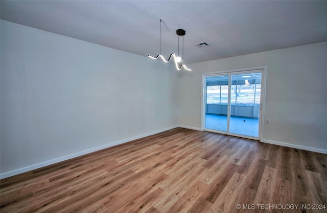 empty room with hardwood / wood-style floors