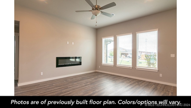 spare room featuring ceiling fan and dark hardwood / wood-style flooring