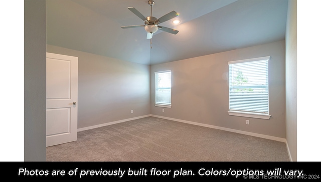 empty room featuring light carpet, plenty of natural light, and lofted ceiling