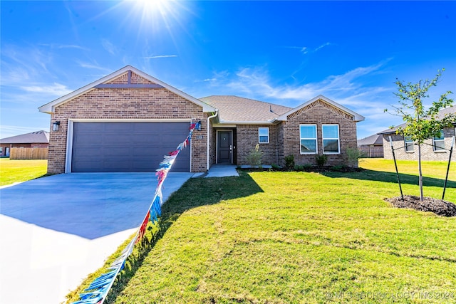 single story home with a front lawn and a garage