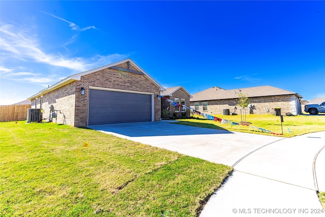 ranch-style home featuring central AC unit, a garage, and a front lawn