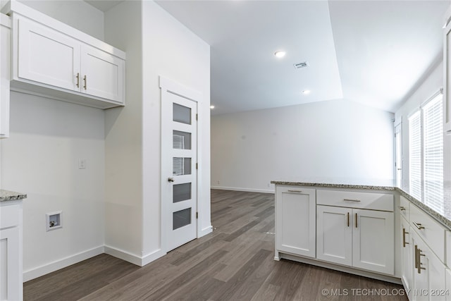 kitchen with white cabinets, dark hardwood / wood-style flooring, and light stone countertops