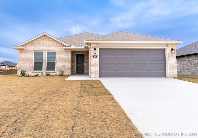 ranch-style home with a garage and a front yard