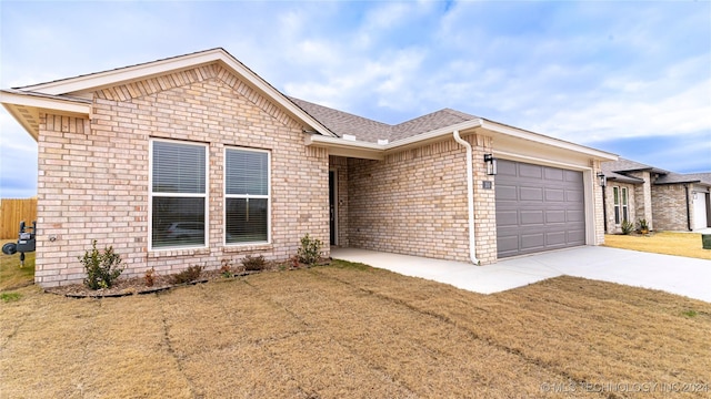 ranch-style house with a front yard and a garage