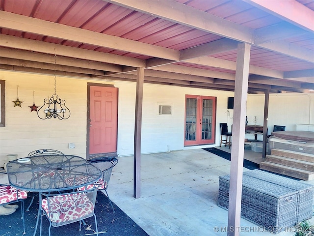 view of patio / terrace with french doors and a hot tub