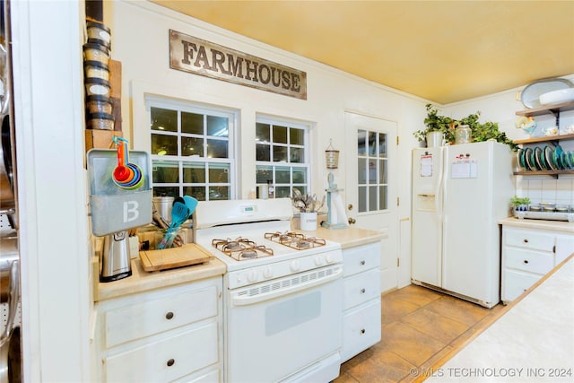 kitchen featuring white cabinets, white appliances, crown molding, and light tile patterned floors