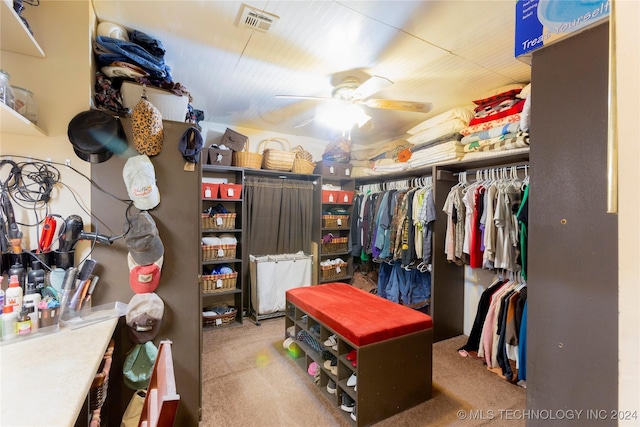 spacious closet with light carpet and ceiling fan