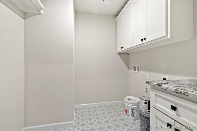 washroom featuring washer hookup, hookup for an electric dryer, and cabinets