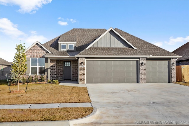 view of front of home with a garage and a front lawn