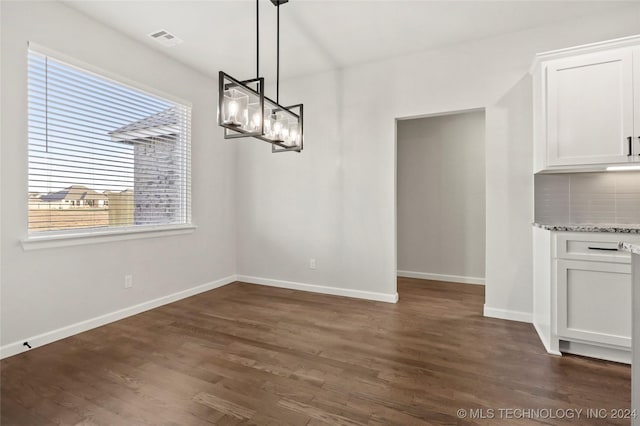 unfurnished dining area with dark hardwood / wood-style flooring