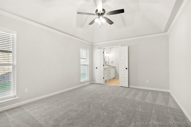 unfurnished bedroom featuring connected bathroom, ceiling fan, light colored carpet, and ornamental molding