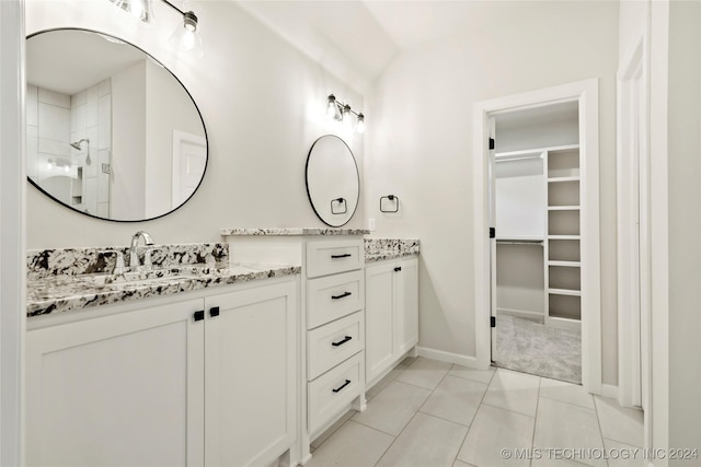 bathroom featuring tile patterned floors, vanity, and walk in shower